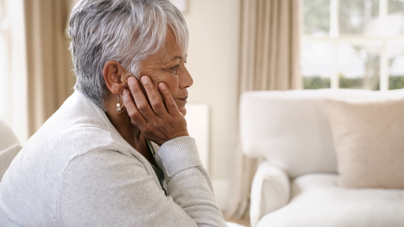 woman who is a caregiver sitting down tired