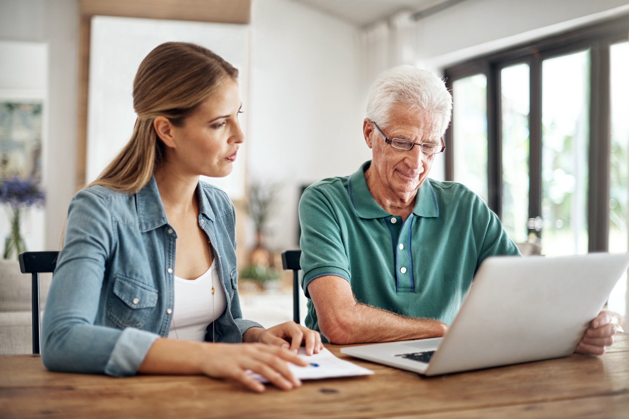 Senior man reviewing assisted living with his adult daughter