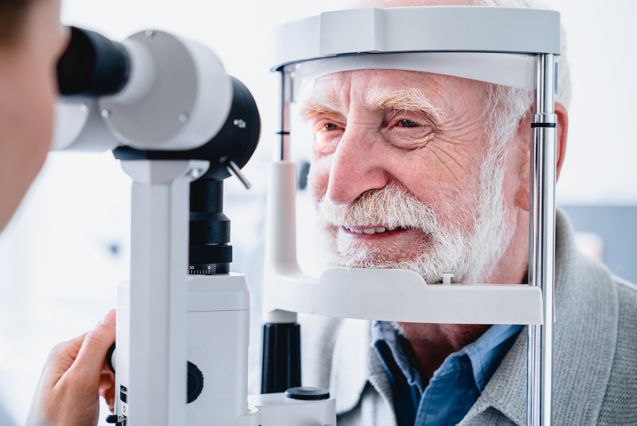 Close up photo of smiling senior male patient during sight examination