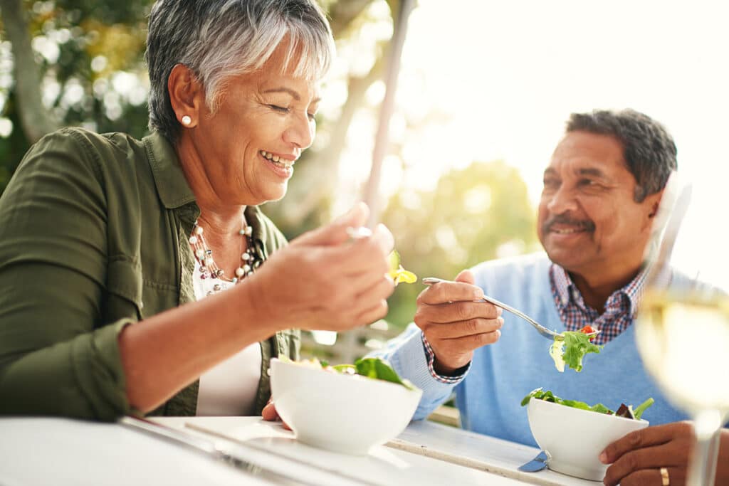 Shot of a happy older couple enjoying a healthy lunch together outdoors