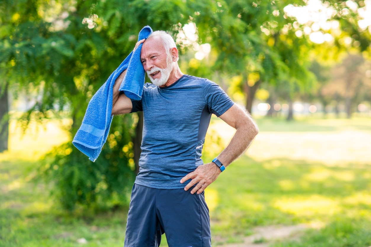 Senior man taking a break after exercising in the park.