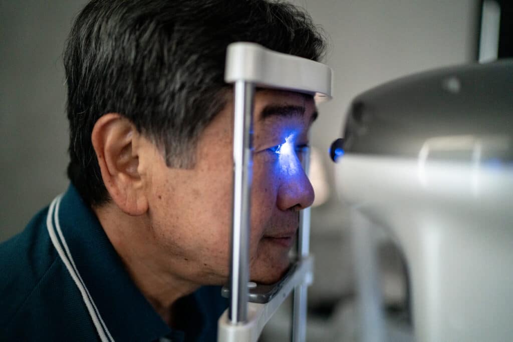 Senior man doing an eye exam in a medical clinic