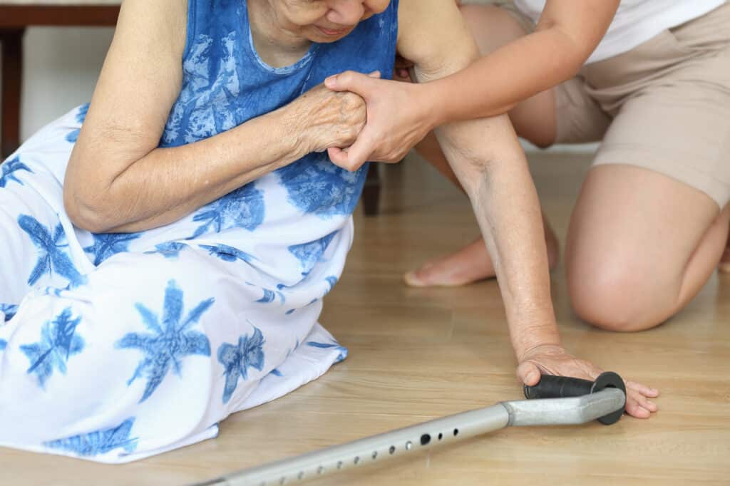 Elderly woman falling down at home - fall risk.
