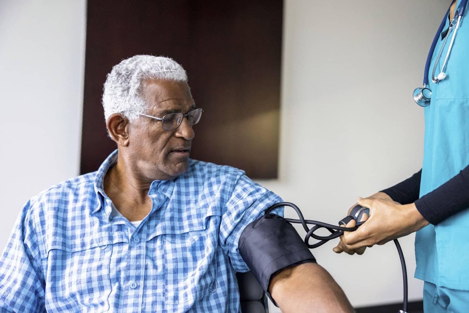 elderly man getting his blood pressure checked